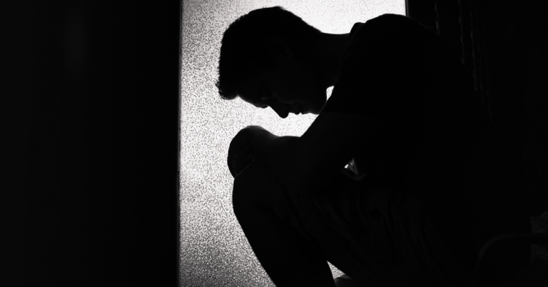 Depressed Man Sitting On Floor