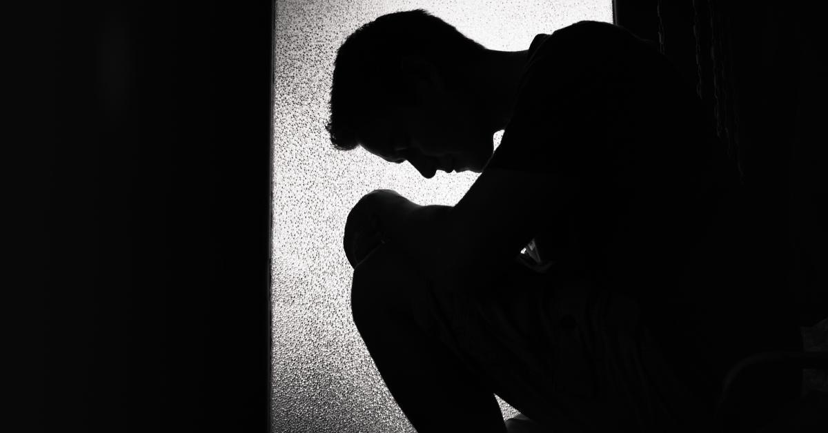 Depressed Man Sitting On Floor